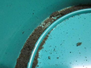 A later type of foam inner seal decomposes into a tar-like sticky goo with small sticky particles.