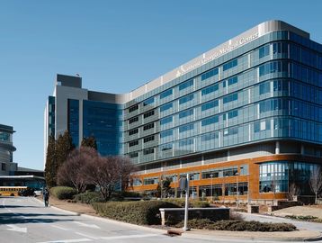 Exterior of a modern hospital building under clear sky.