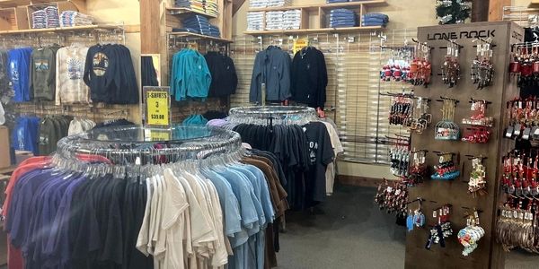 Clothing store with racks of t-shirts and souvenirs on display.