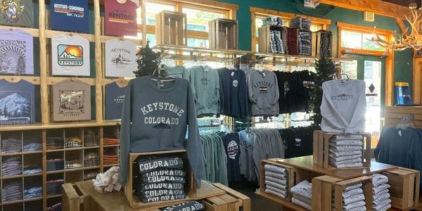 Cozy Keystone Colorado apparel displayed in a rustic store setting.