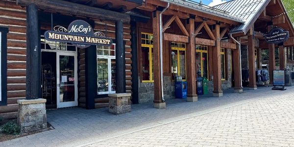 Exterior of McCoy's Mountain Market with wooden log cabin style architecture.
