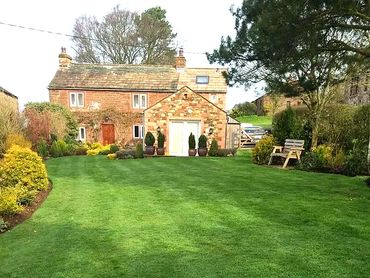 well maintained lawn outside a cottage