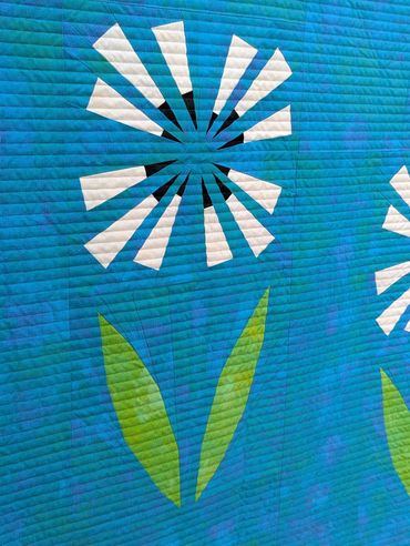 My first shot at straight line quilting!  Gives a modern look to this paper pieced quit.  Dandelion