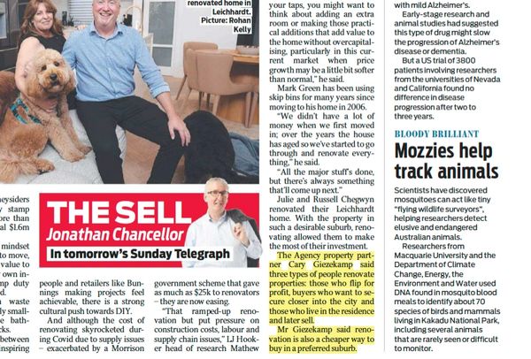 A man sitting with a dog and a newspaper article about property renovation.