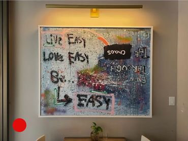 A painting by Genesis, Acrylic mixed with Latex and spray paint sitting inside a handmade frame.