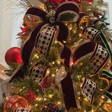 Close-up of a Christmas tree adorned with elegant ribbons and ornaments.
