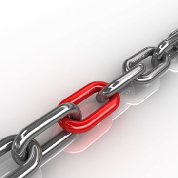 A silver chain with one red link in the middle.