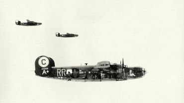 Three vintage military bombers flying in formation against a clear sky.