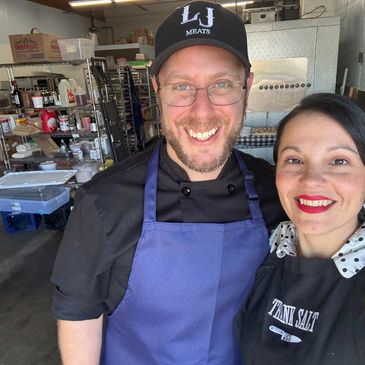 Chef and beautiful wife smiling.