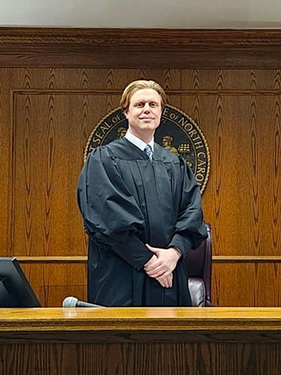 Judge Daniel Hines Entzminger in judicial robe standing on the bench.