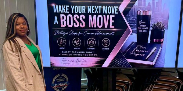 Woman standing next to a career advancement motivational sign.