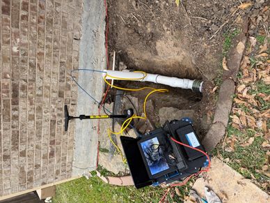 A setup for underground pipe inspection with a camera and pump.