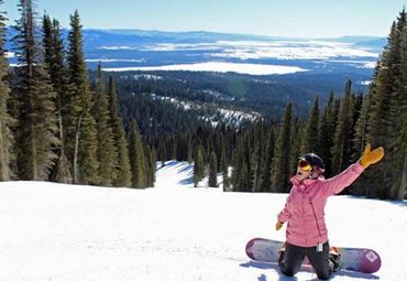 Woman snowboarding on a mountain in Idaho. Photo credit: David Foster