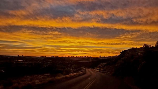 driving into the sunset in Idaho. Photo Credit: Mike Gaudreau