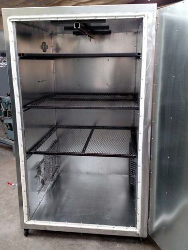 Empty metal smoker with open door.
