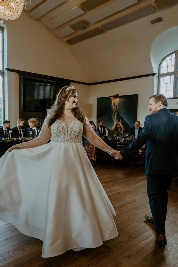 Bride and groom share a joyful dance at their wedding reception.