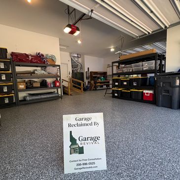 Clean and organized garage with storage shelves and sign.