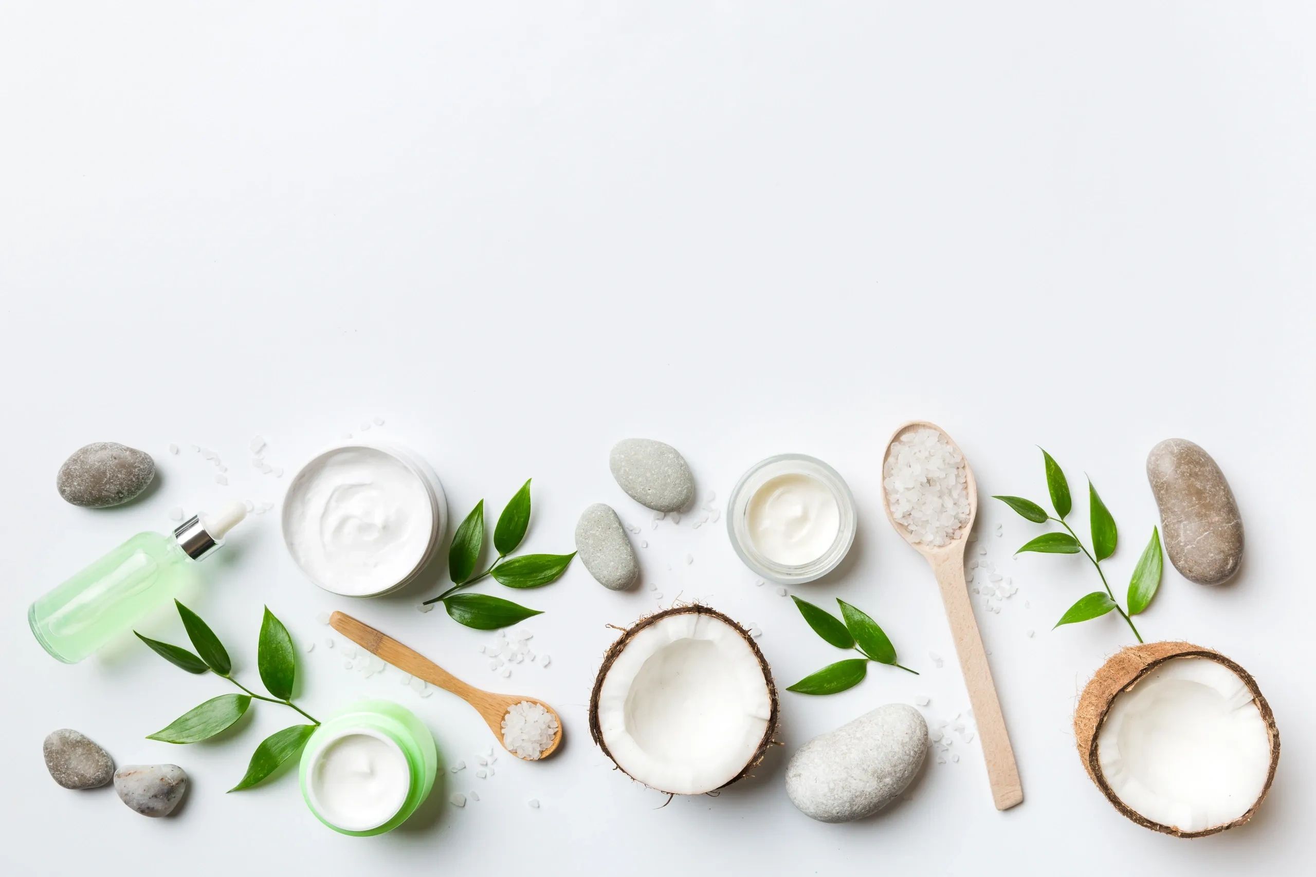 Natural skincare ingredients with cream and coconut.