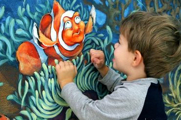 child viewing clownfish mural painting