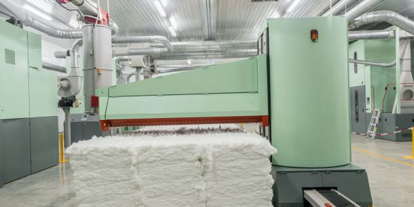 Carding passes the clean and dry wool through wire rollers to straighten the fibers, producing soft