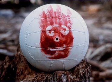 White volleyball with a red handprint on it.