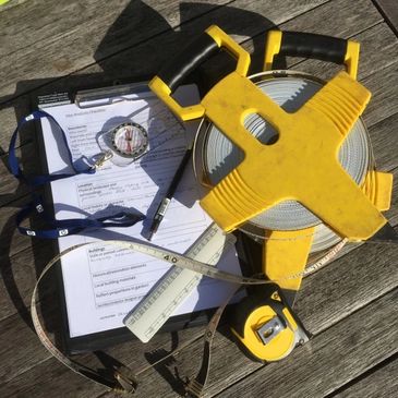 measuring tapes and surveying equipment on a table