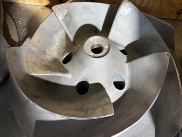 Old metal turbine or impeller part with four blades.