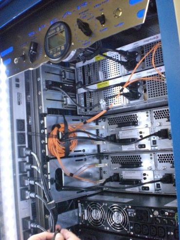 Close-up of a server rack with cables and hardware components.