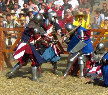 Medieval combat reenactment in front of an audience.
