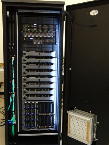 Open server rack with Dell PowerVault storage units and network equipment.