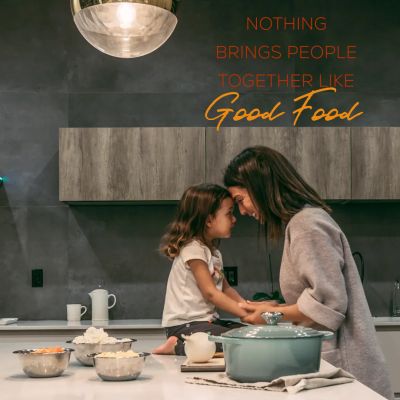 Mother and daughter bonding in kitchen with cooking pots.