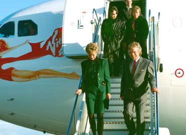 Princess Diana descends the stairway with Richard Branson after an inaugural naming flight of a new