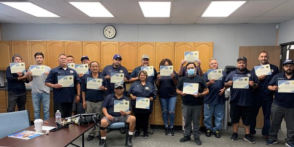 Azusa custodians displaying their ISSA certificates.