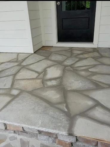 High End Custom paver design on front porch of house