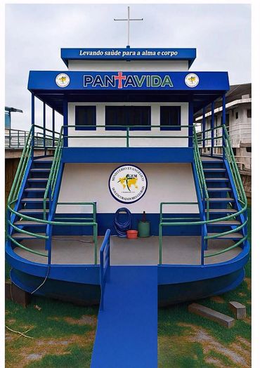 Blue and white floating church with dual staircases and a cross on top.