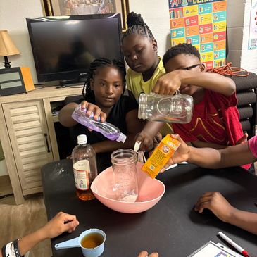 Kids doing a science experiment with household items.