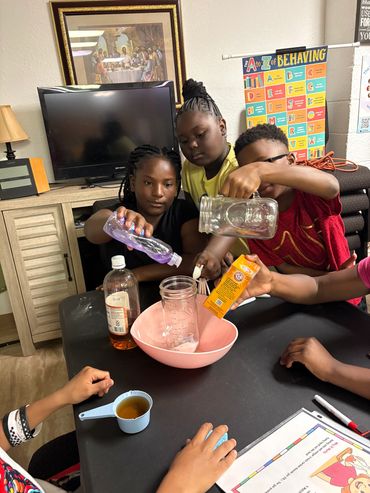 Children mixing ingredients in a bowl for a science experiment.