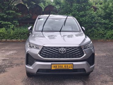 Front view of a silver Toyota car with windshield wipers raised.