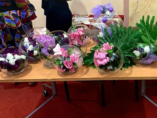 Different flowers placed on a table at a charitable event