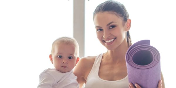 Baby Yoga Instructor holding a baby.