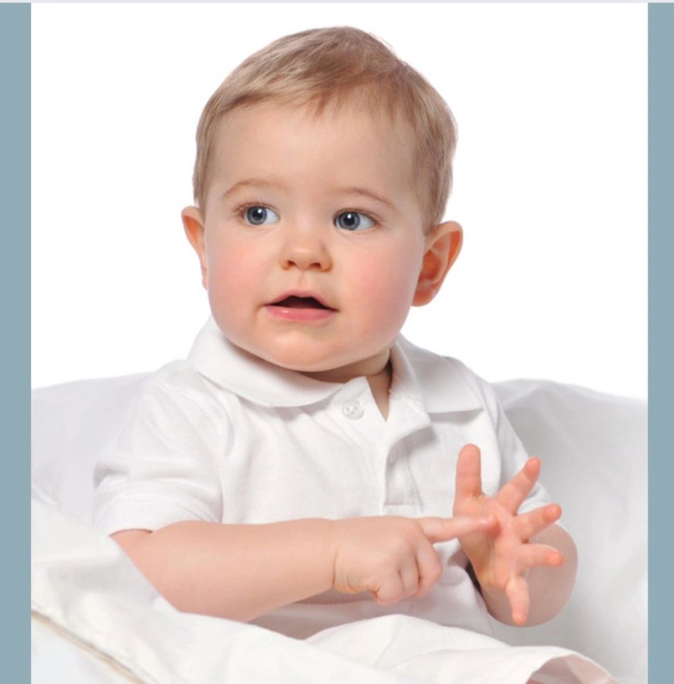 A toddler using baby sign language.