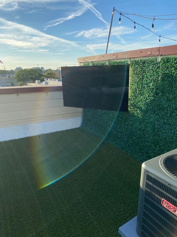 TV mounted on rooftop in loft setting.