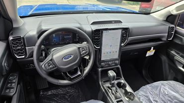 Modern Ford truck interior with digital dashboard and large touchscreen display.