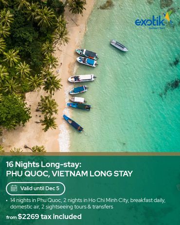 Aerial view of boats by a tropical beach in Phu Quoc, Vietnam for a long stay tour.