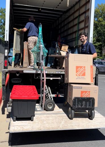 Our crew manager loading the moving truck with packed boxes in Acworth Georgia