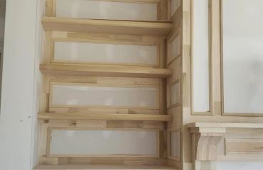 Wooden shelving unit with white panels.