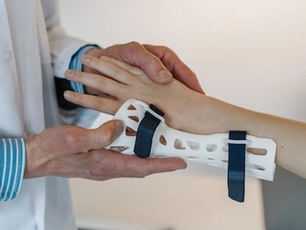 Doctor putting a brace on patient's wrist