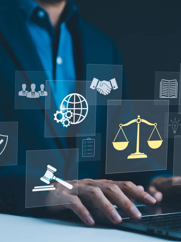 Person typing on a laptop with legal icons floating.