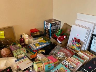 A table filled with assorted office and craft supplies organized in a corner.