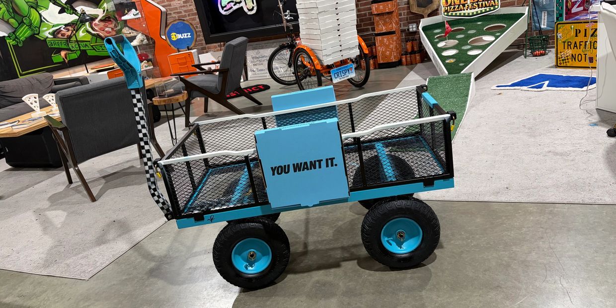 Blue cart with the text 'YOU WANT IT.' in an indoor recreational space.